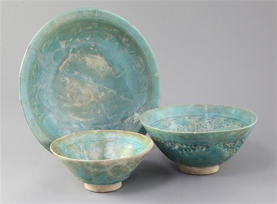 Two Kashan turquoise glazed pottery bowls and a similar dish, 13th century, diameter 15cm - 25.5cm, restorations